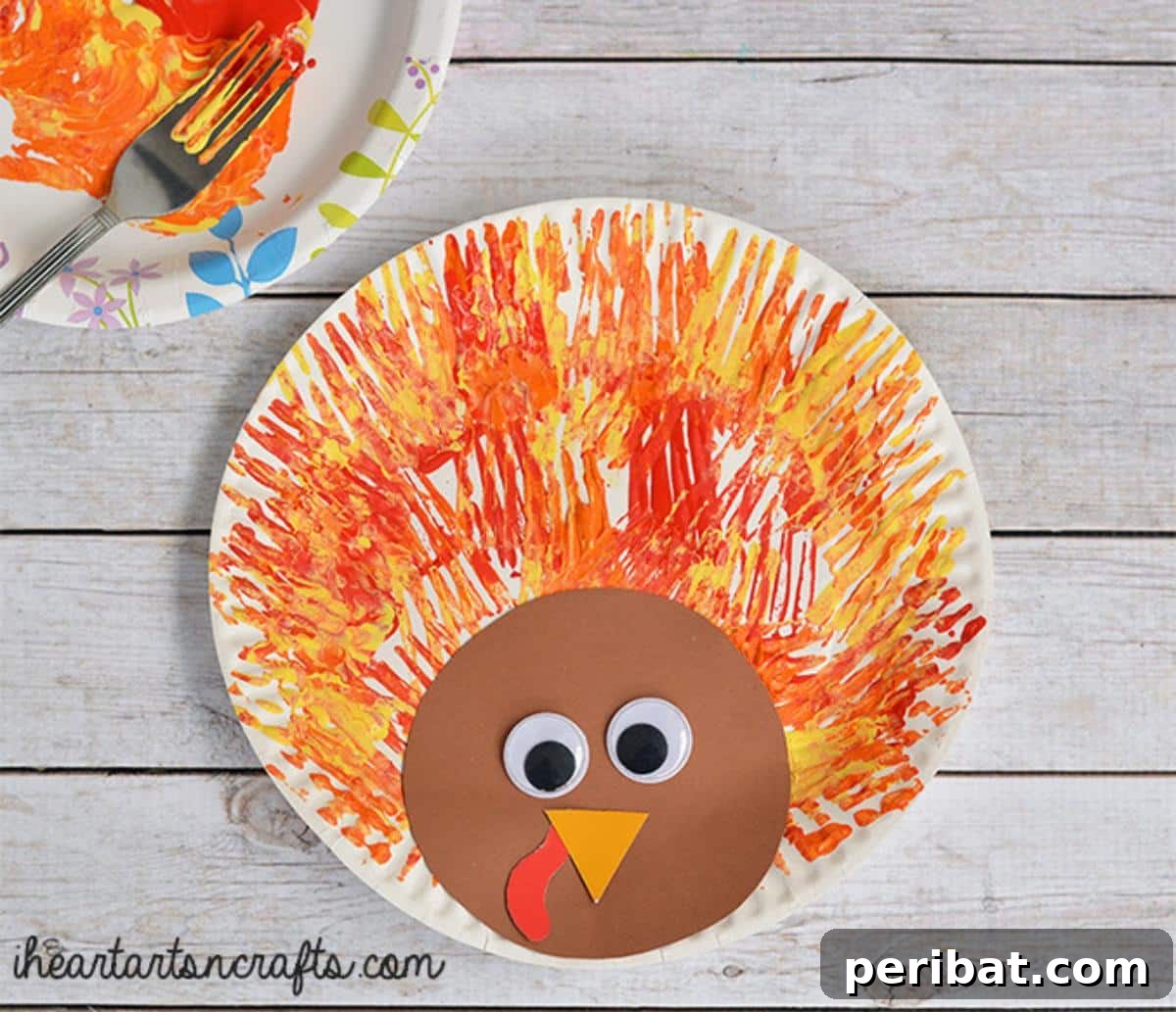 A turkey craft for kids, featuring feather-like patterns created with fork painting.