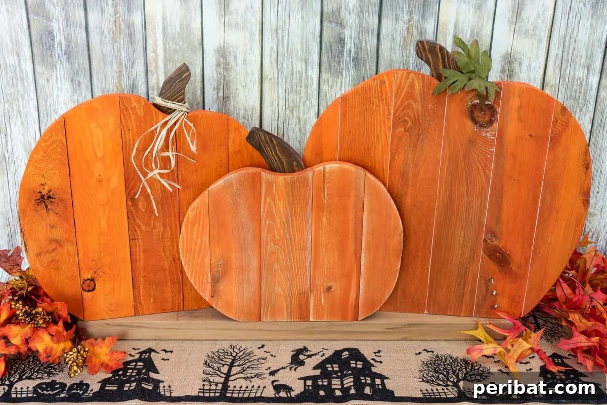 Simple Wooden Pumpkin Crafts for Autumn Decor 18 Festive DIY pallet pumpkin trio for autumn decorations.