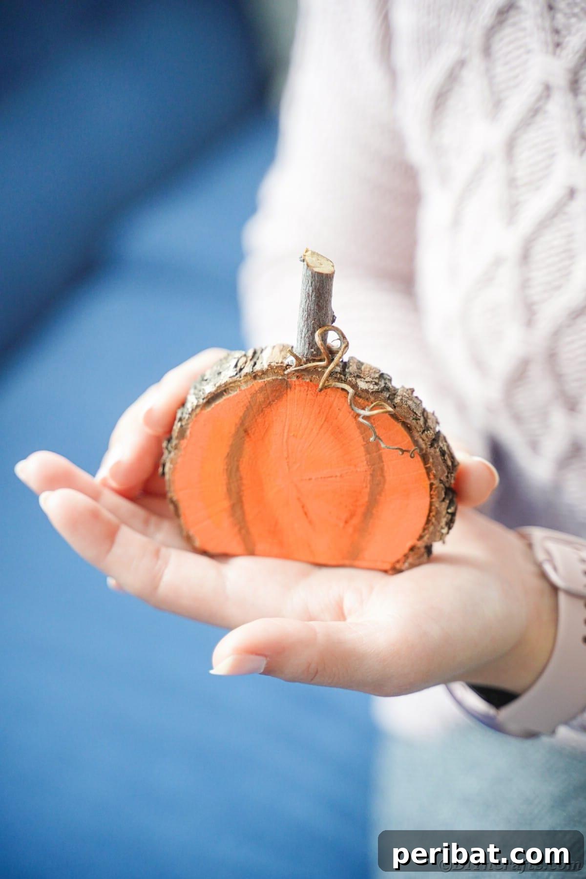 Simple Wooden Pumpkin Crafts for Autumn Decor 3 Rustic DIY painted wood slice pumpkin decoration with autumn leaves.