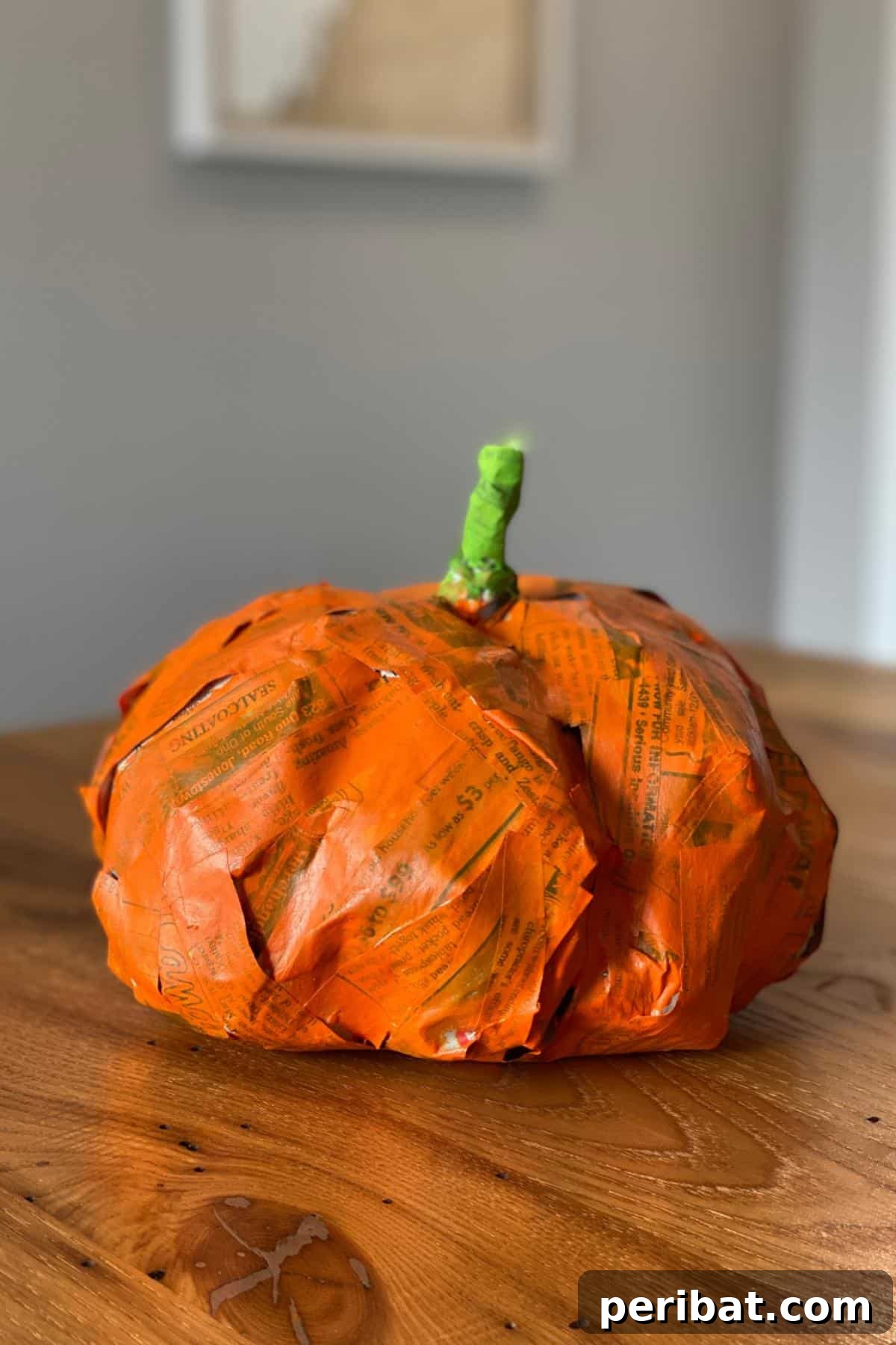 33 Creative Paper Mache Pumpkin Ideas 11 An inspiring recycled paper mâché pumpkin crafted from trash, perfect for eco-friendly fall decoration.