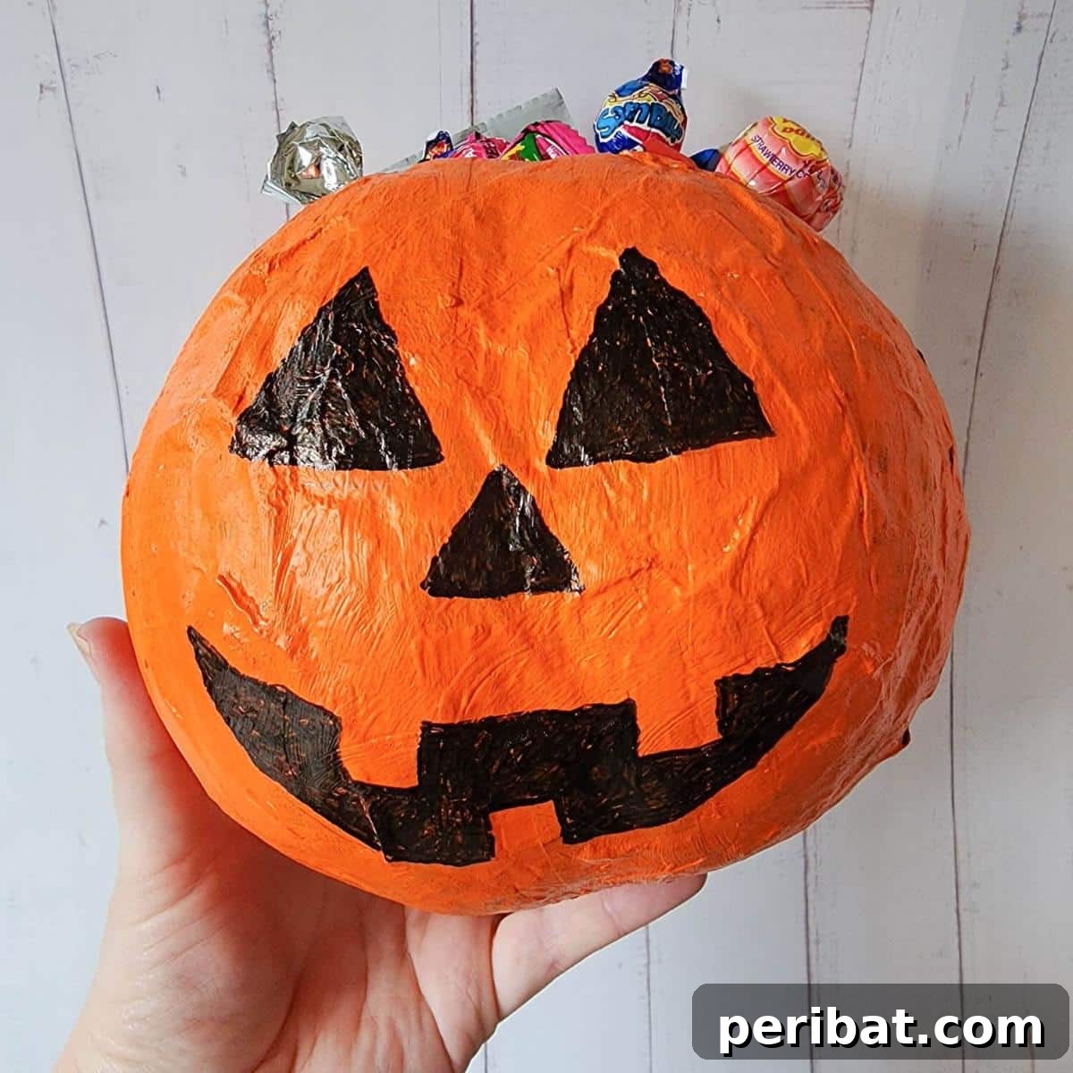 33 Creative Paper Mache Pumpkin Ideas 18 A cheerful Papier Mache Jack O Lantern, ready to personalize Halloween celebrations with its glowing charm.