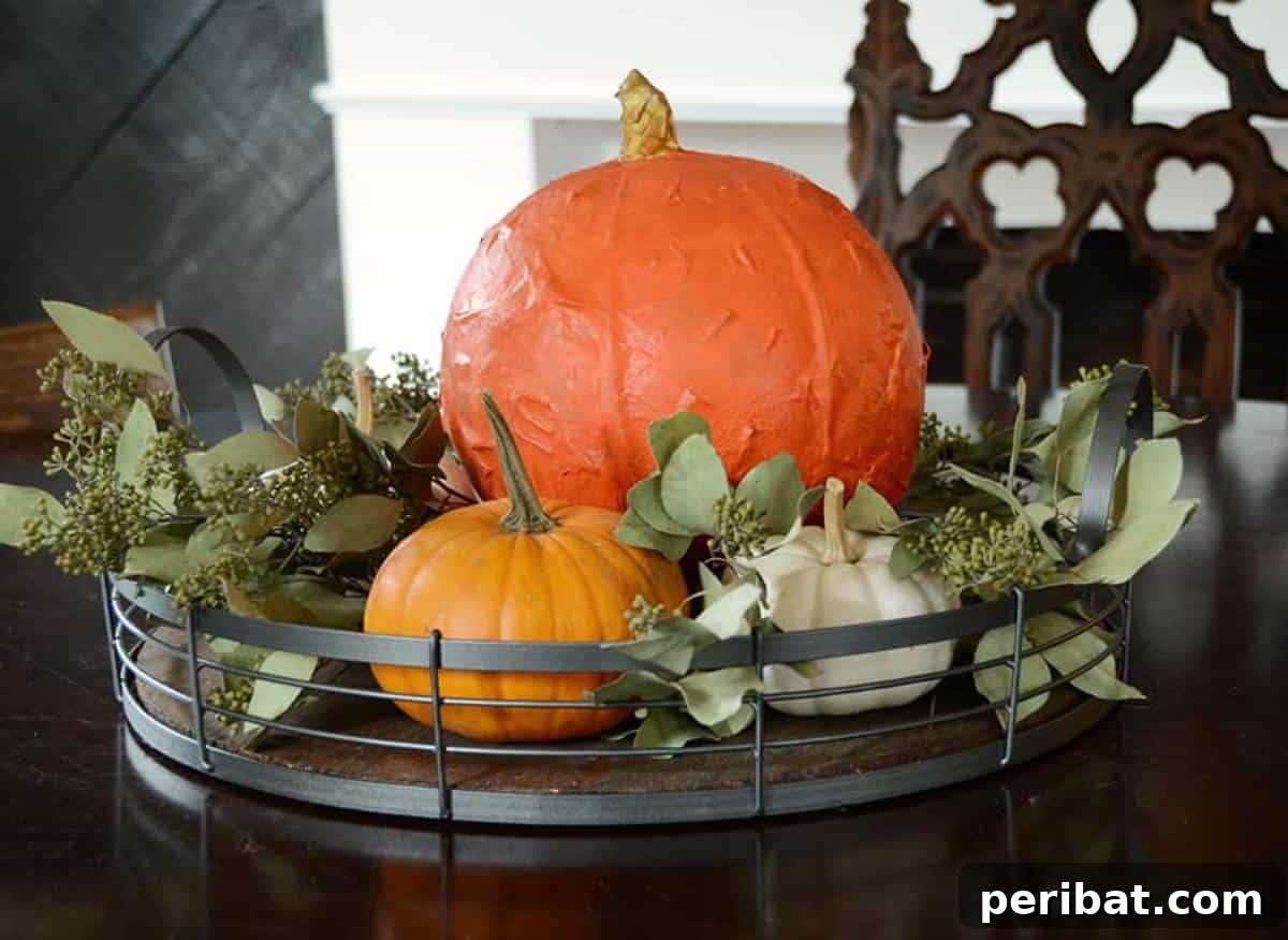 33 Creative Paper Mache Pumpkin Ideas 24 A DIY Paper Maché Pumpkin, accompanied by a step-by-step tutorial for creating durable, customized fall decor.