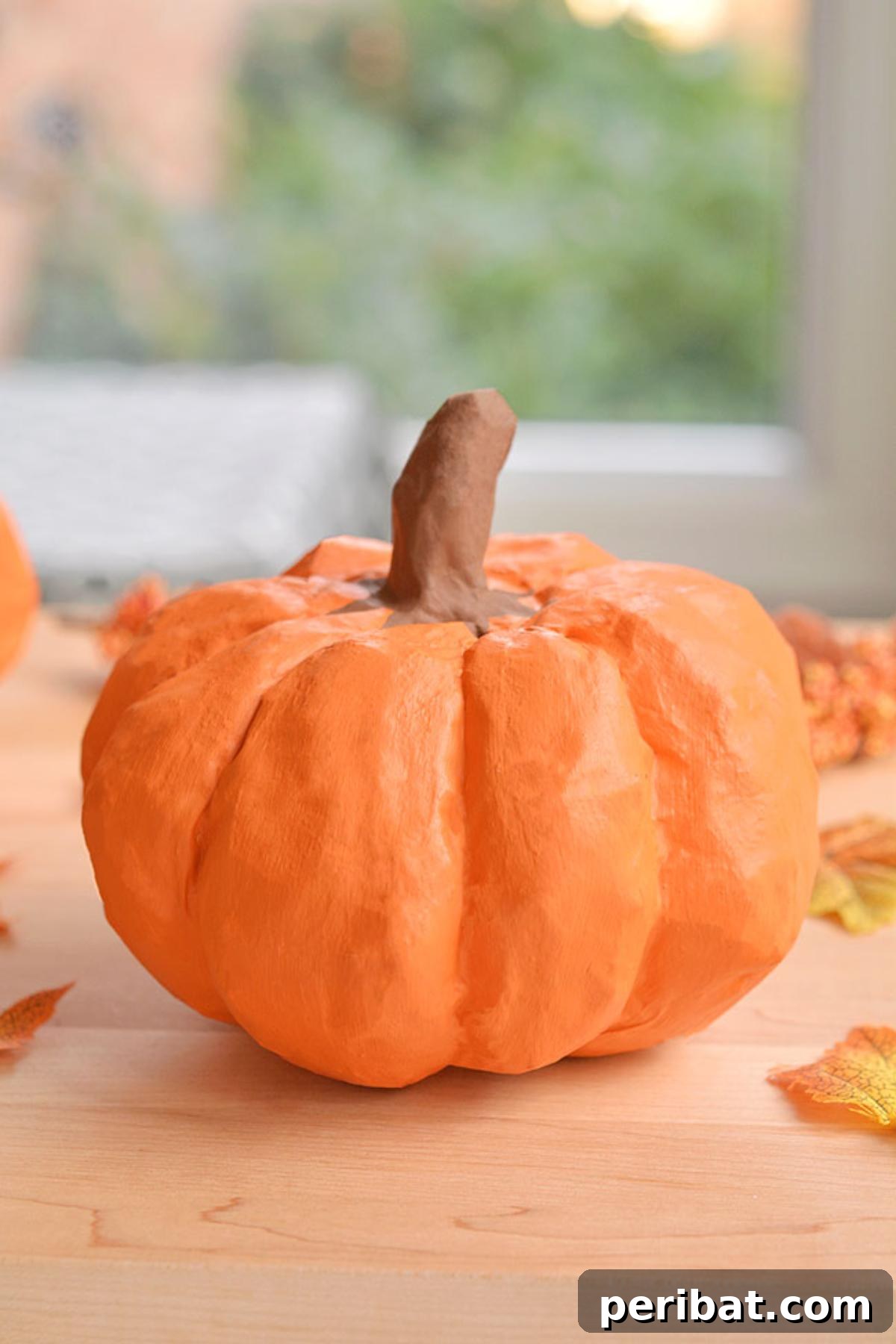 33 Creative Paper Mache Pumpkin Ideas 4 A beautifully customized paper mache pumpkin, demonstrating how simple materials can create unique fall decor.