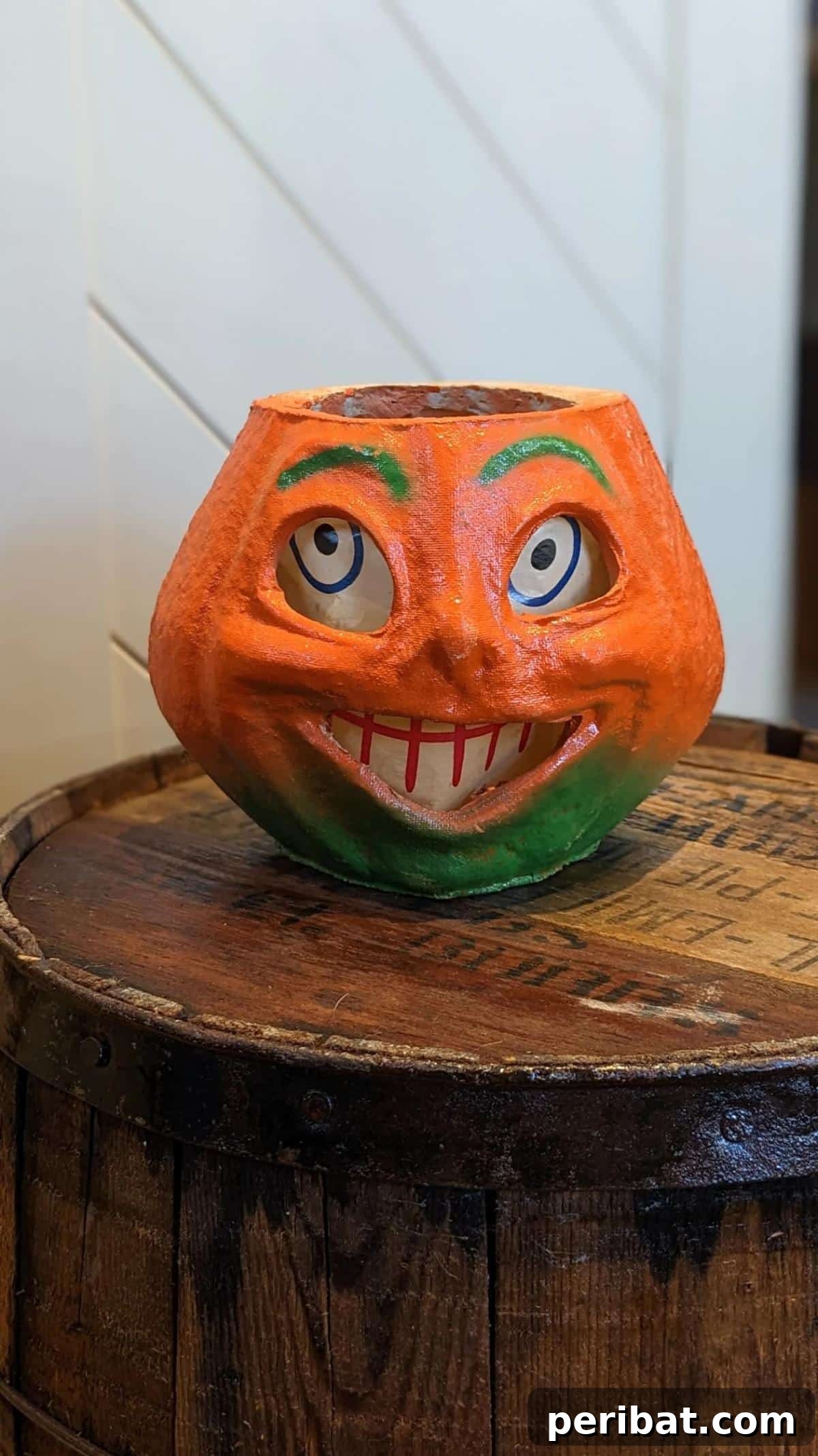 33 Creative Paper Mache Pumpkin Ideas 32 A classic Vintage Paper Mache Pumpkin featuring an original paper face insert, offering a whimsical peek into Halloween's past.