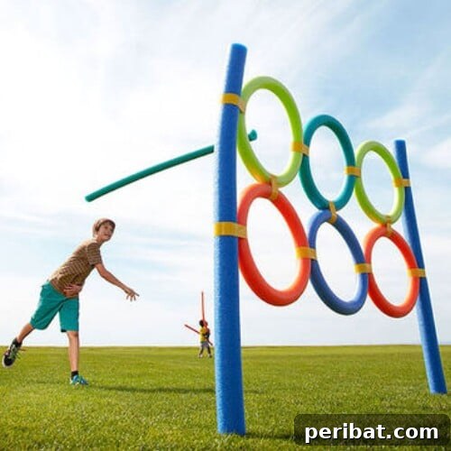 Kids playing a pool noodle toss game in the backyard