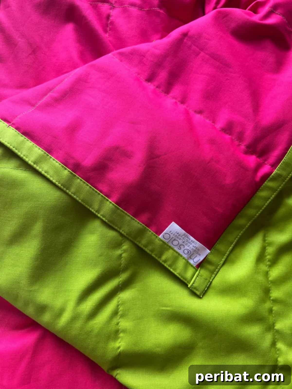 28 Soothing DIY Weighted Blanket Projects 19 A vibrant collection of Colorful DIY Weighted Blankets, showcasing diverse fabric patterns and bright hues.