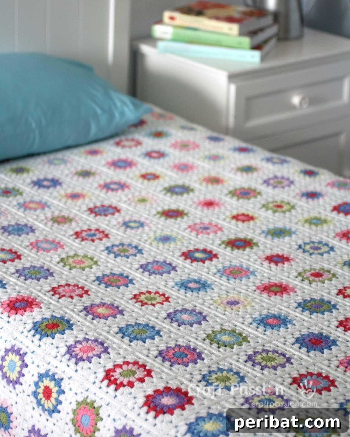 A beautifully crocheted Sunburst Granny Square Blanket, radiating warmth and vibrant colors.
