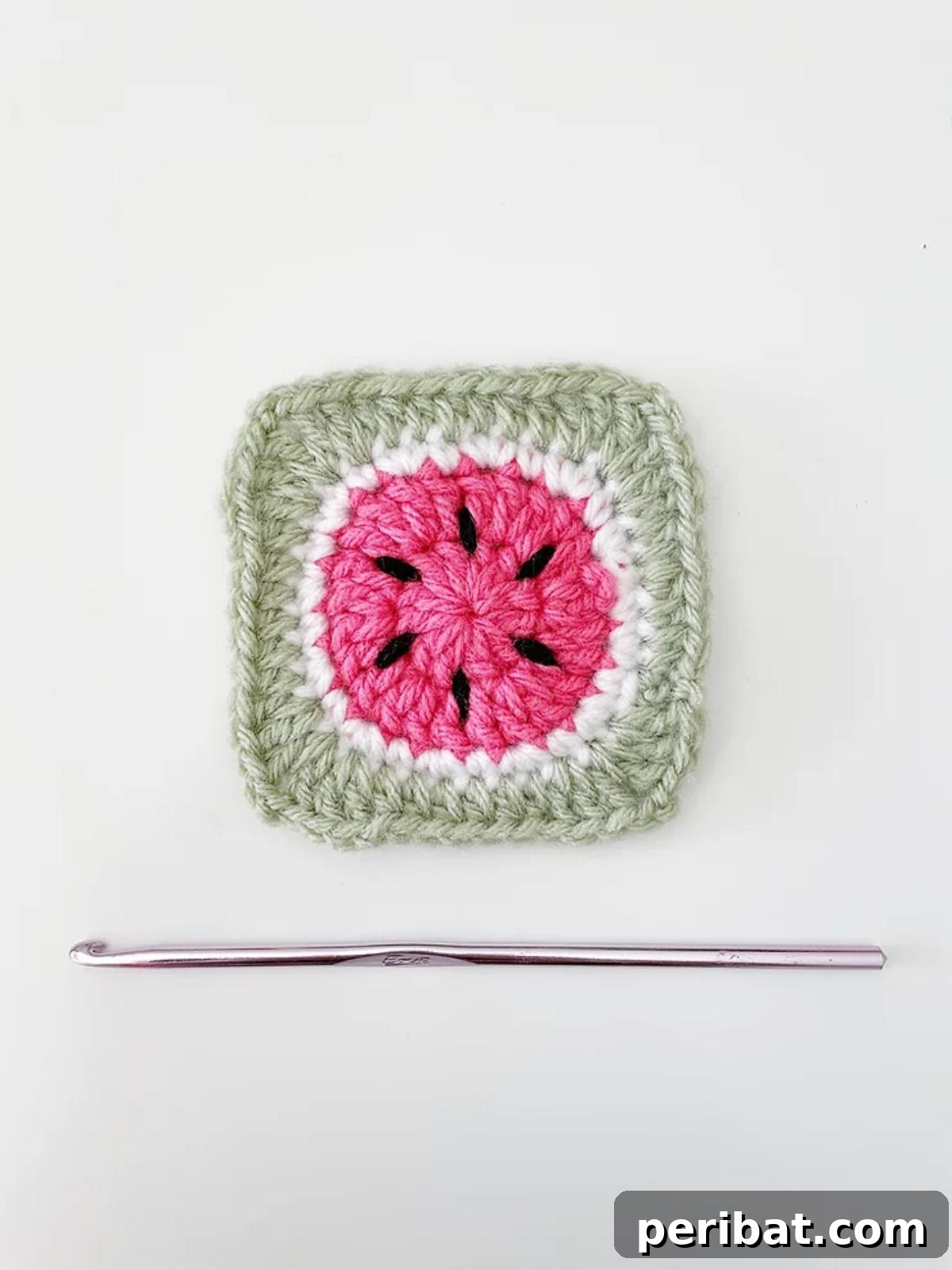 Refreshing Watermelon Granny Square with green rind, pink flesh, and black seeds.