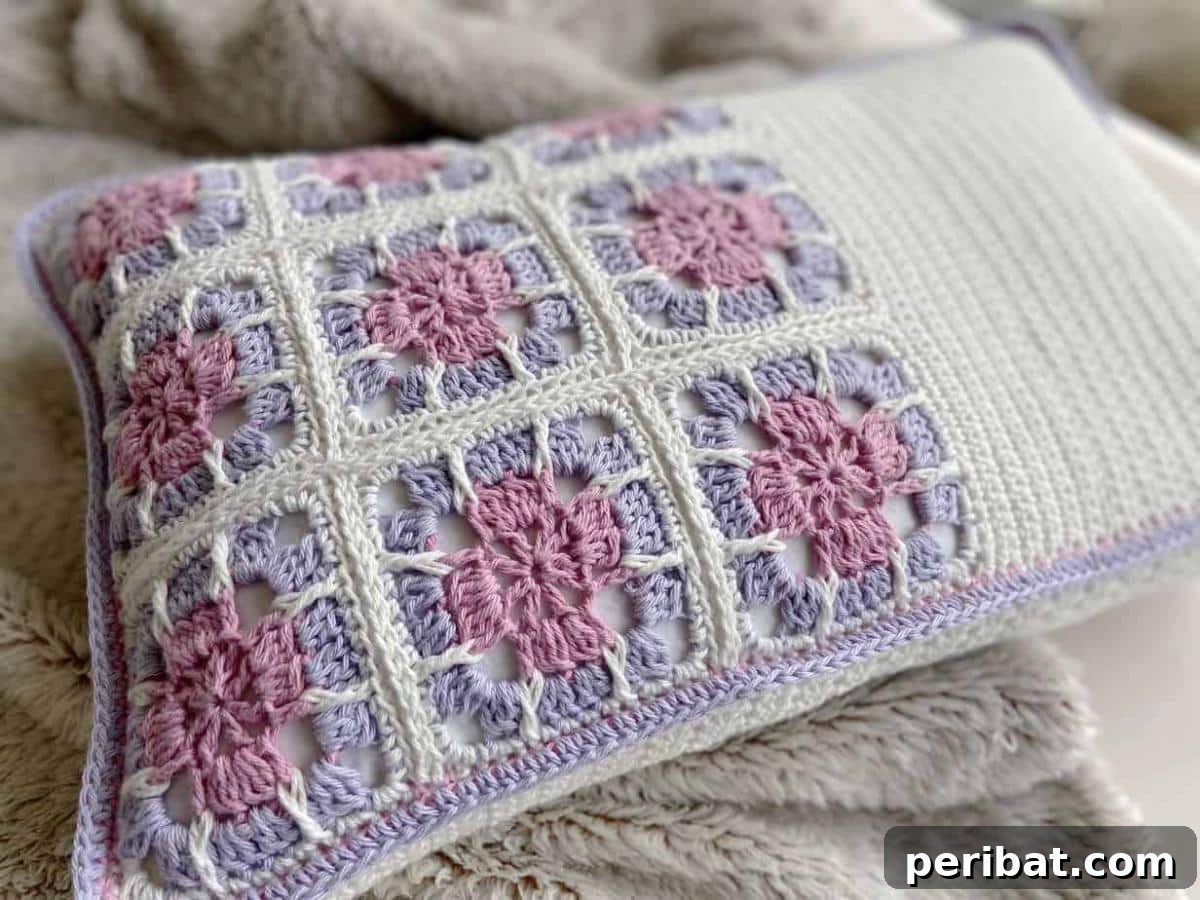 A charming Floral Granny Square Cushion, adorned with intricate crochet blooms and leaves.