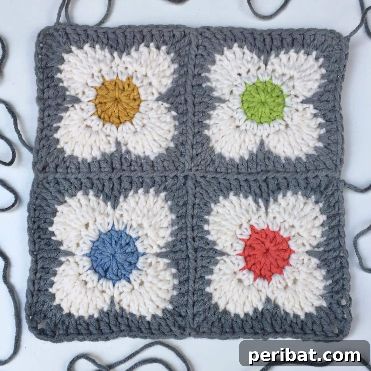 A cheerful OK Flower Crochet Motif with bright petals and a contrasting center.