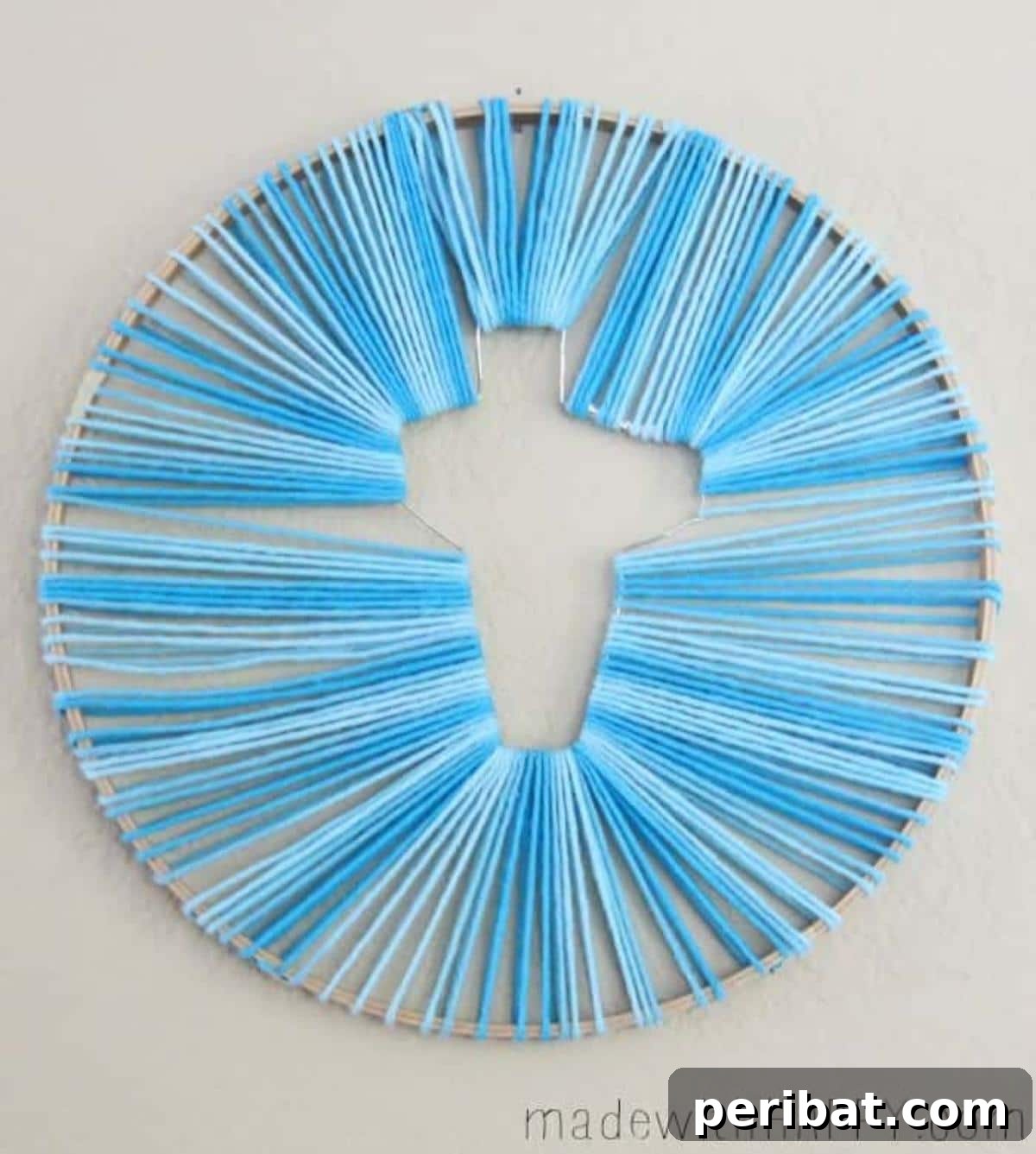 Hoop Easter cross string art made with yarn.