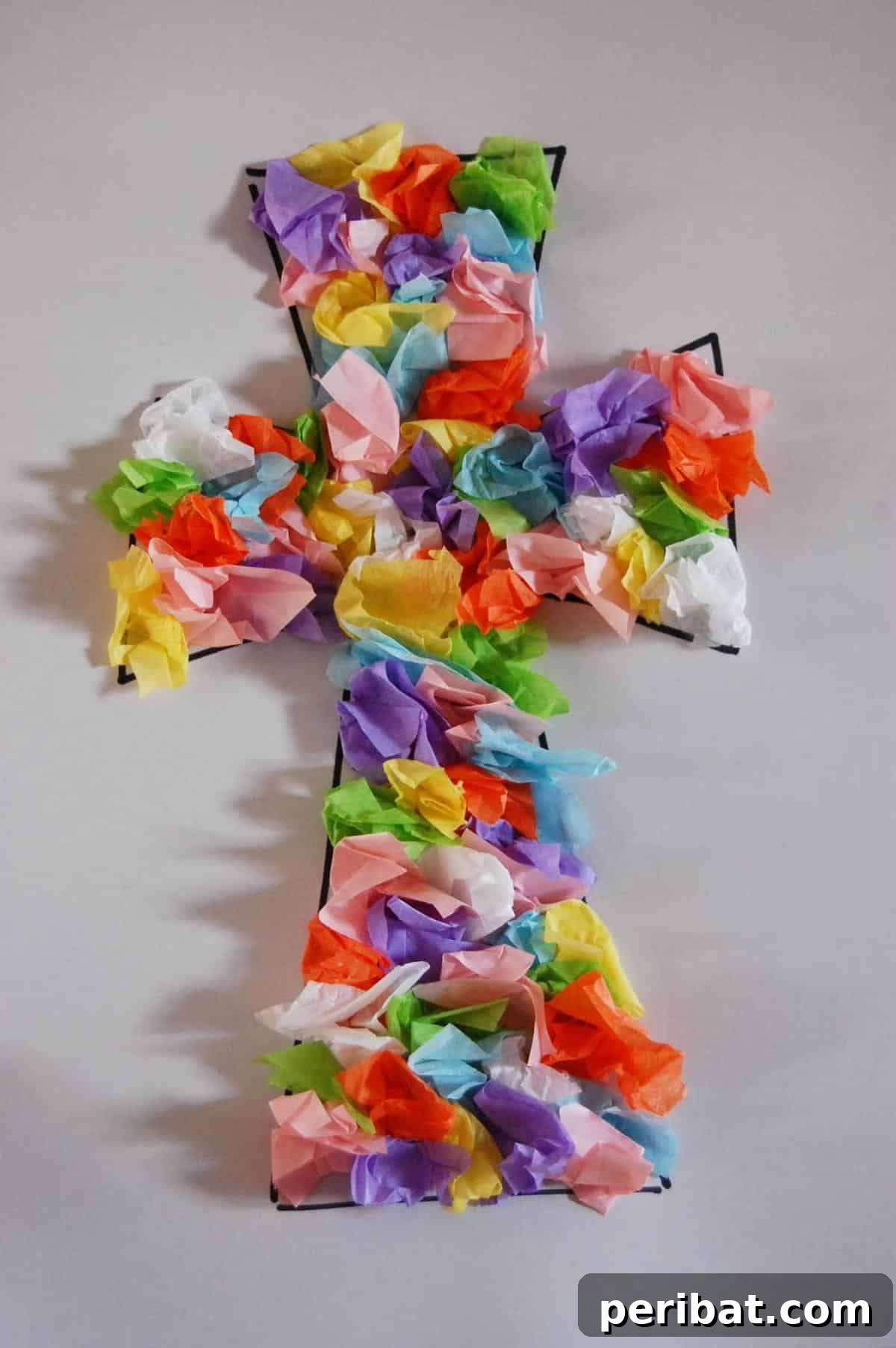A preschool Easter cross craft made with crumpled tissue paper for texture.