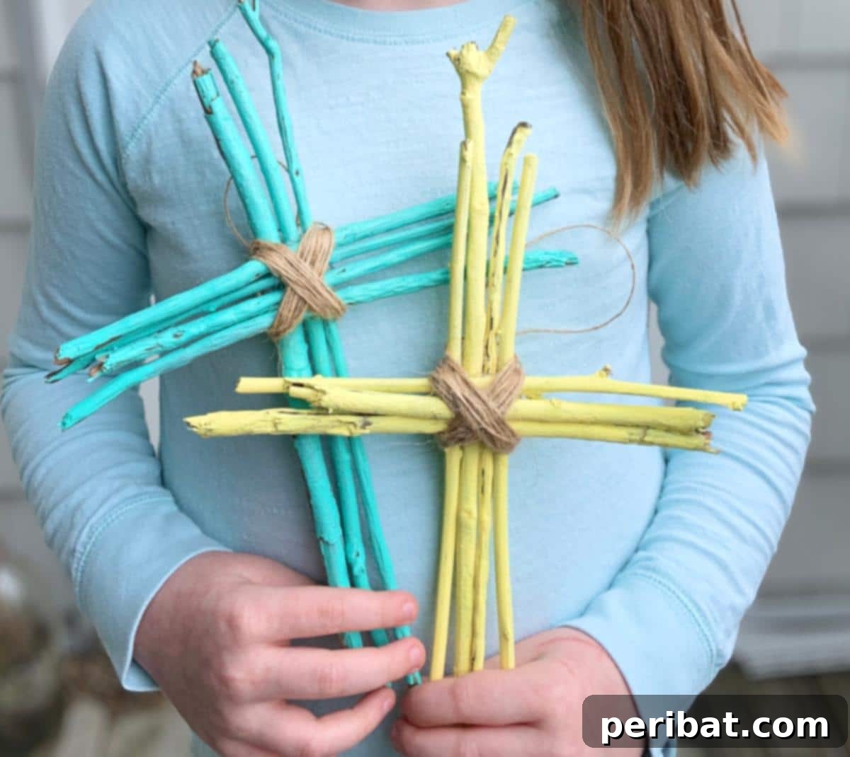 A nature-inspired Easter cross craft made from sticks and natural elements.