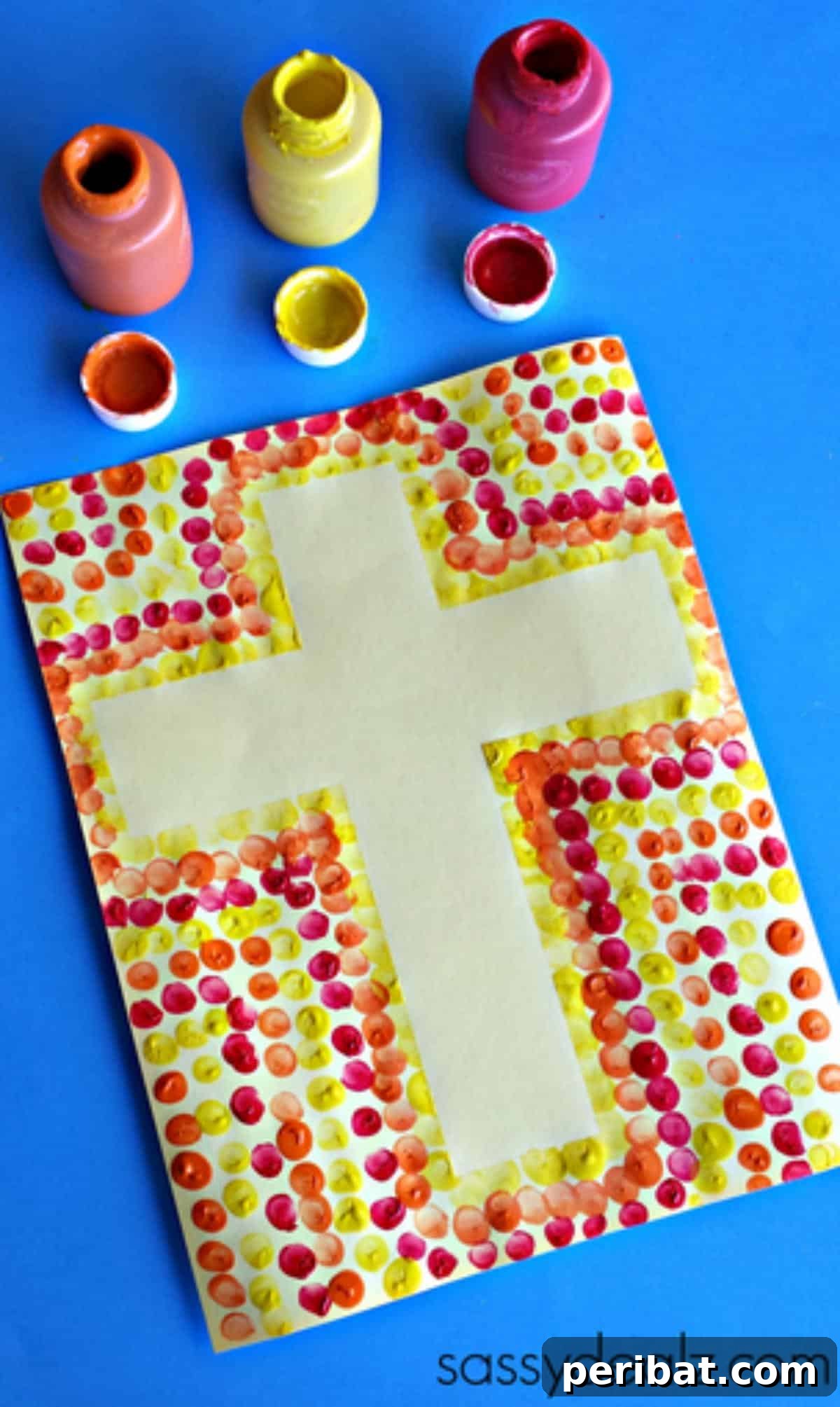 Children's fingerprint art forming a colorful border around a cross shape.