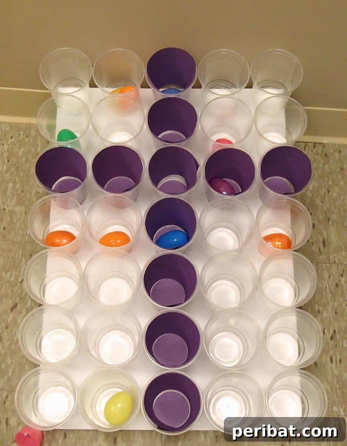 Children playing an Easter egg toss game with questions inside the eggs.