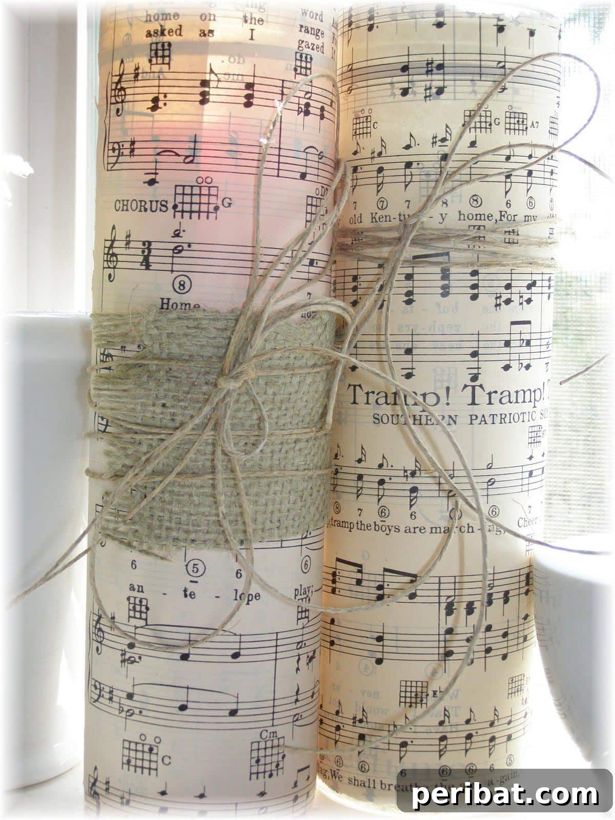 Crafting Melodies 40 Sheet Music Projects 21 A pillar candle elegantly wrapped with sheet music, creating a refined decorative piece.