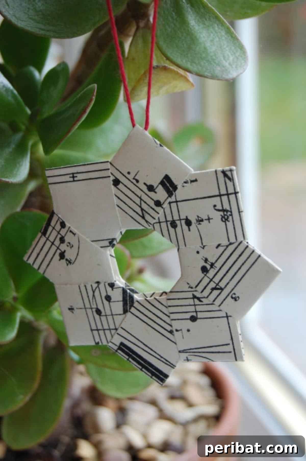 Crafting Melodies 40 Sheet Music Projects 22 An intricate origami wreath crafted from folded sheet music, showcasing delicate paper artistry.