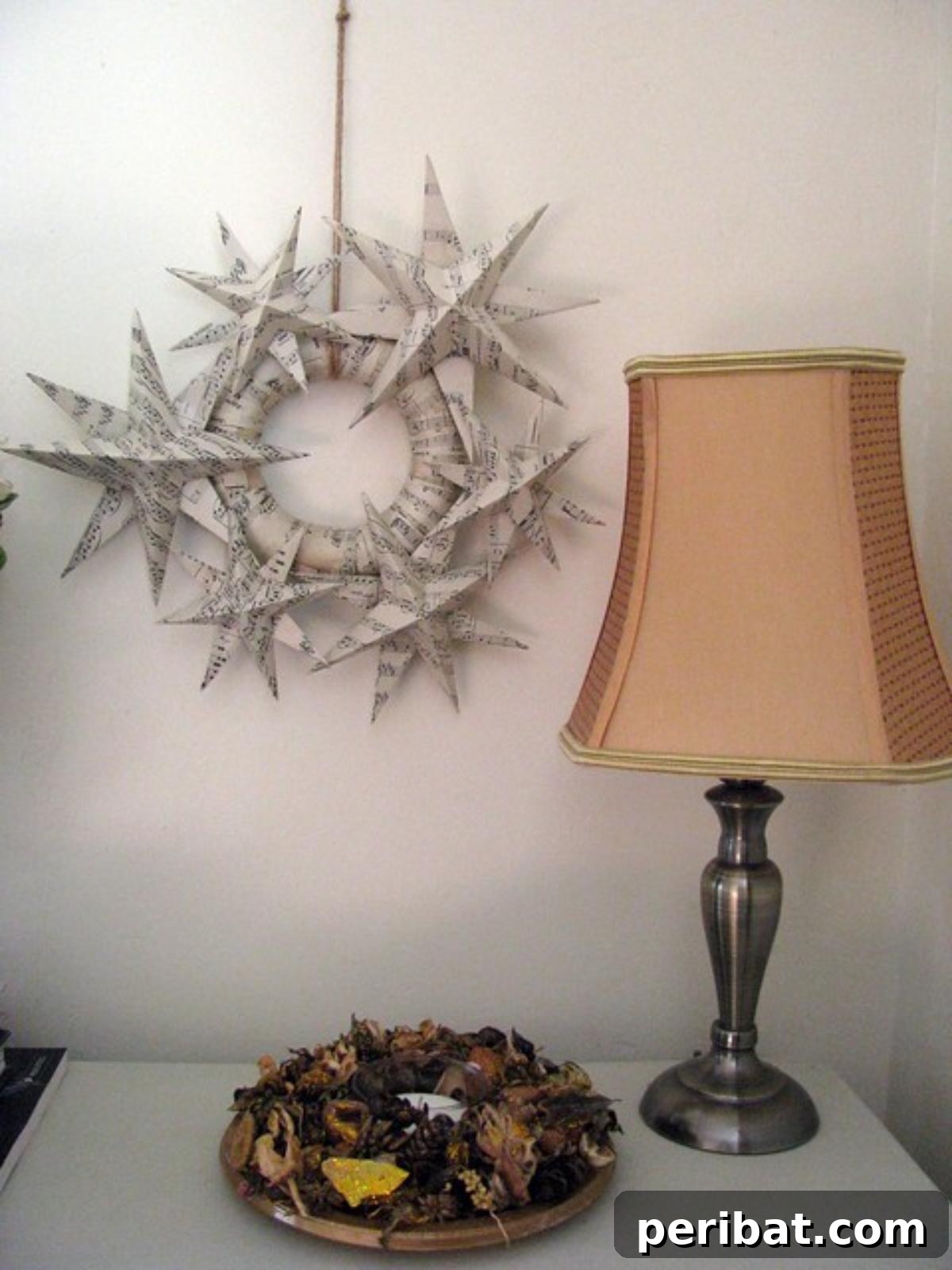Crafting Melodies 40 Sheet Music Projects 28 A festive Christmas star wreath artfully constructed from sheet music, giving a vintage holiday feel.
