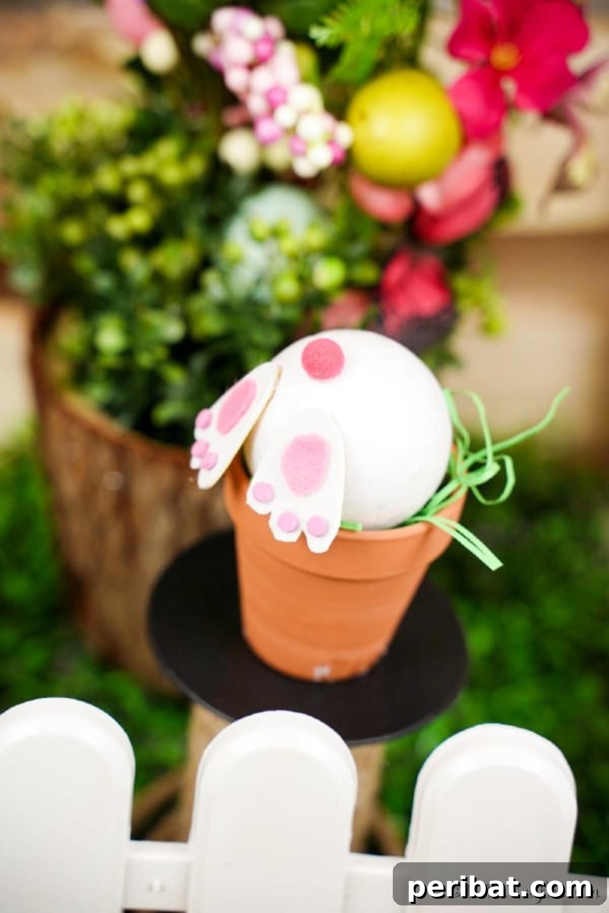 40 Creative Flower Pot Projects 7 A playful Easter decoration featuring a cute bunny peeking out from an adorned flower pot, ready to surprise.