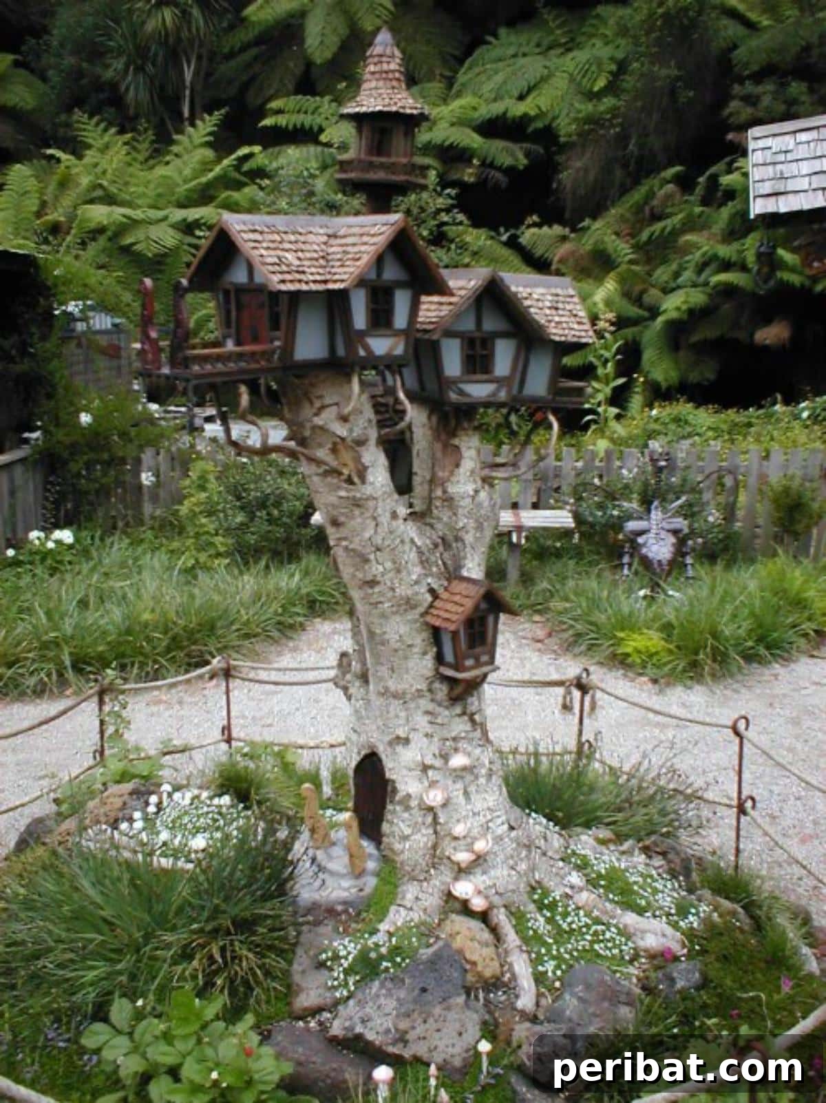 Stump to Splendor Ingenious Garden Planters and Ornaments 14 Magical fairy village constructed on a multi-branched tree stump