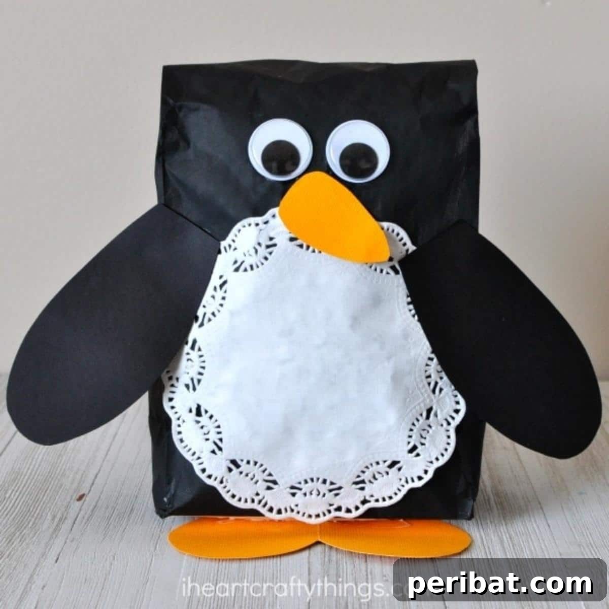 Waddle into Fun: 40 Penguin Craft Projects 15 Super Cute Stuffed Paper Bag Penguin, sitting upright as a cheerful winter decoration.