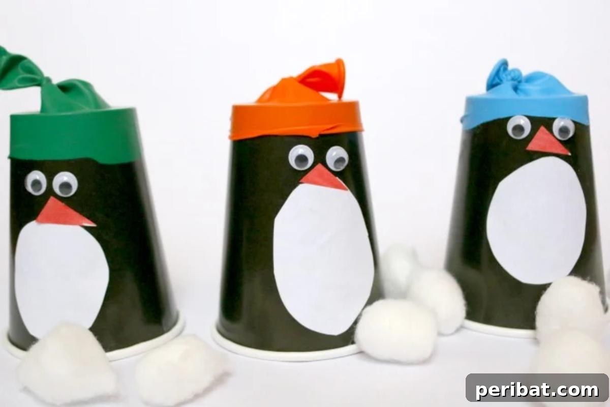 Waddle into Fun: 40 Penguin Craft Projects 36 Easy Paper Cup Penguin Poppers Craft, turning paper cups into exciting pom pom poppers.