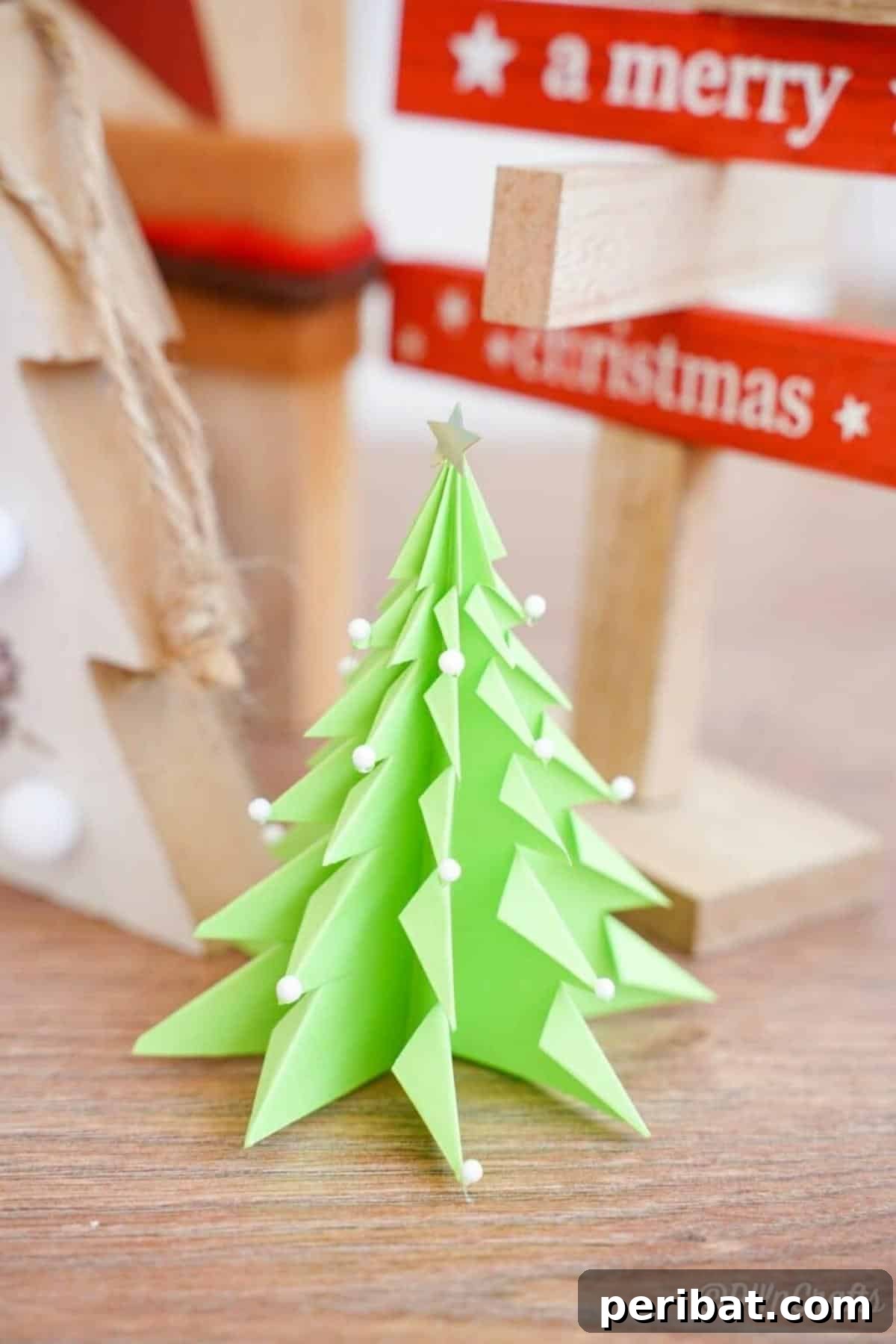 40 Colorful Construction Paper Creations 12 An easy 3D paper mini Christmas tree decoration, crafted from green construction paper and decorated with small colorful accents, ideal for festive tabletop display.