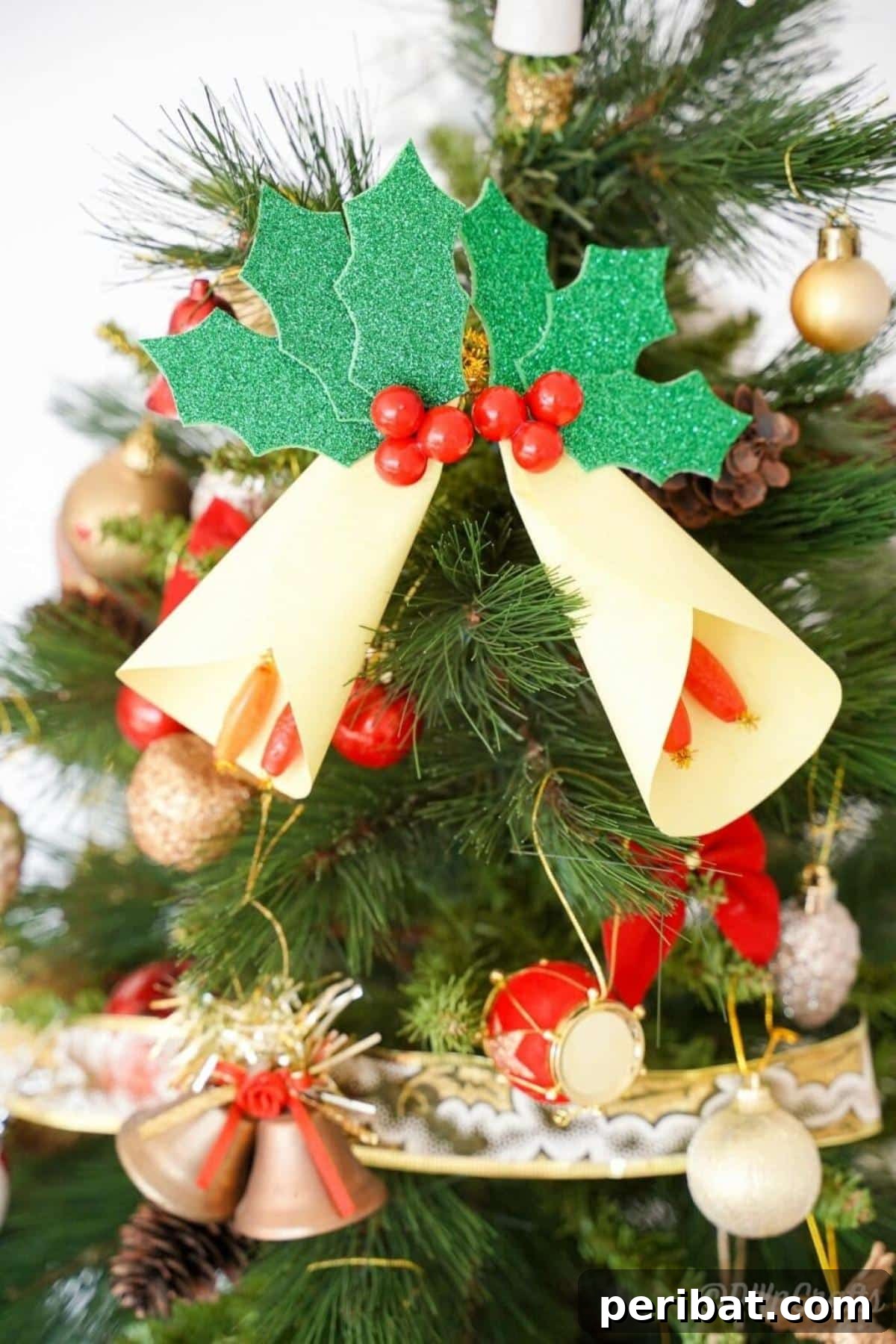 40 Colorful Construction Paper Creations 14 A charming vintage-style paper holly leaf Christmas ornament, made from green paper with red berry accents, perfect for a classic holiday look.