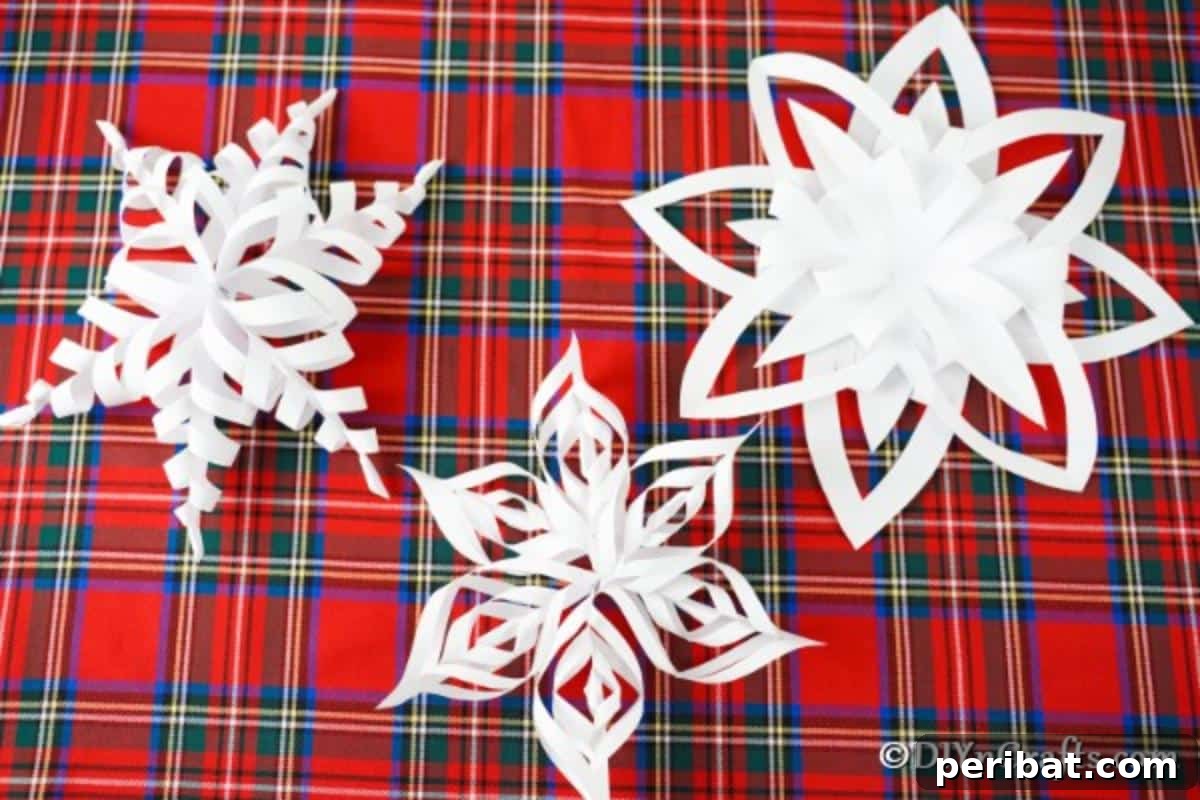 40 Colorful Construction Paper Creations 16 An assortment of easy 3D snowflakes and stars crafted from paper, featuring intricate folds and cuts, perfect for enchanting Christmas decorations.