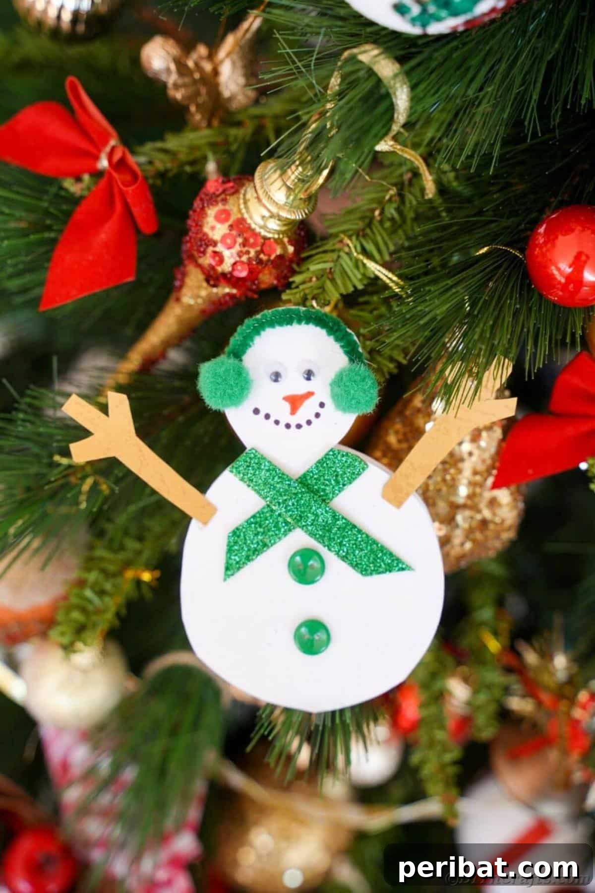 40 Colorful Construction Paper Creations 27 A fun DIY snowman Christmas card for kids, made from white paper cutouts, adorned with a colorful scarf and hat, bringing festive cheer.