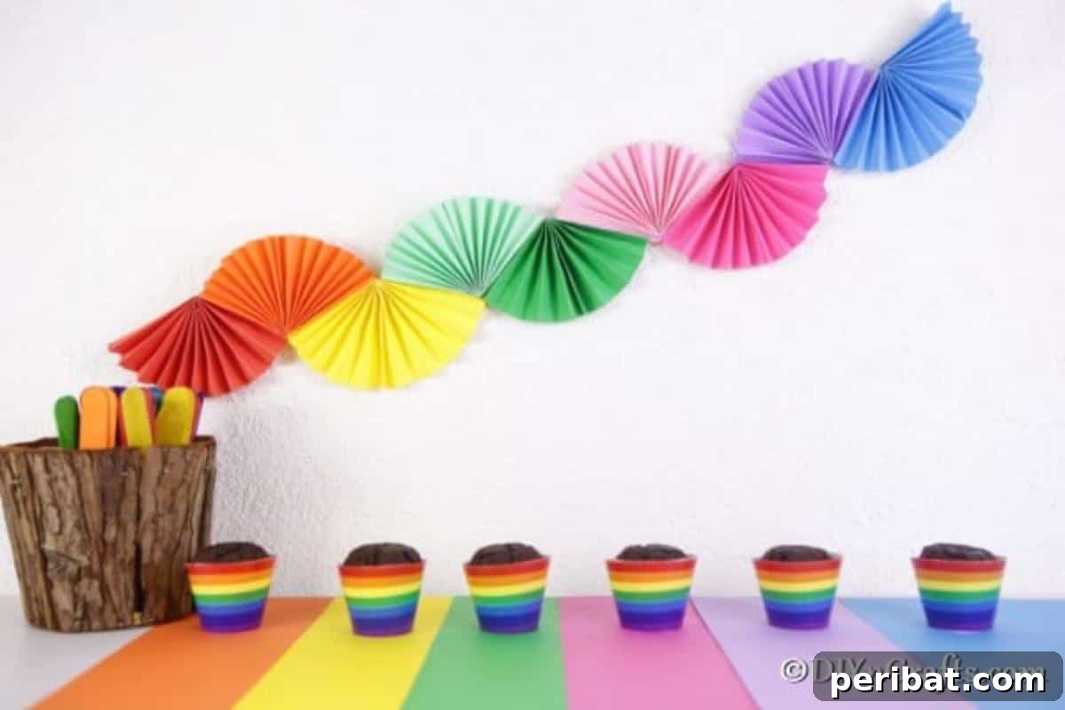 40 Colorful Construction Paper Creations 8 A vibrant DIY paper fan garland featuring an array of colorful folded paper fans strung together, perfect for party decorations or festive ambiance.