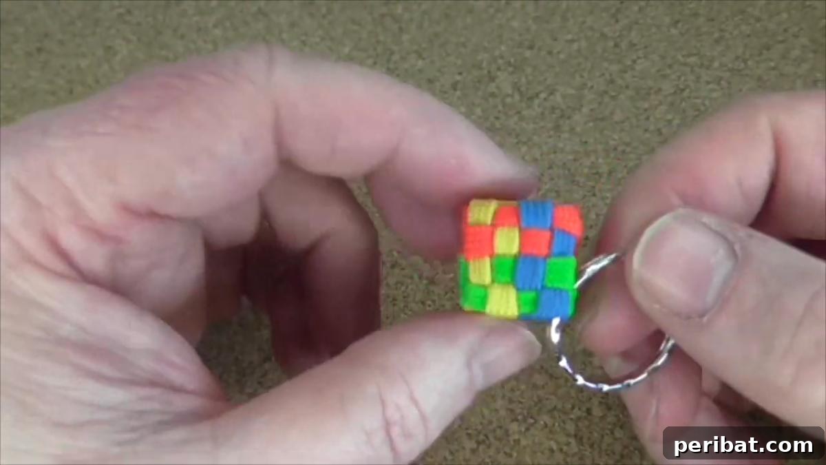 Crafting with Paracord: DIY Ideas and Projects 30 Geometric Cubed Paracord Keychain, resembling a Rubik's Cube.