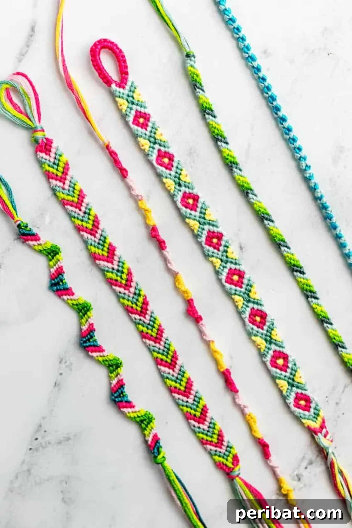 A variety of colorful friendship bracelets with letter beads and charms.