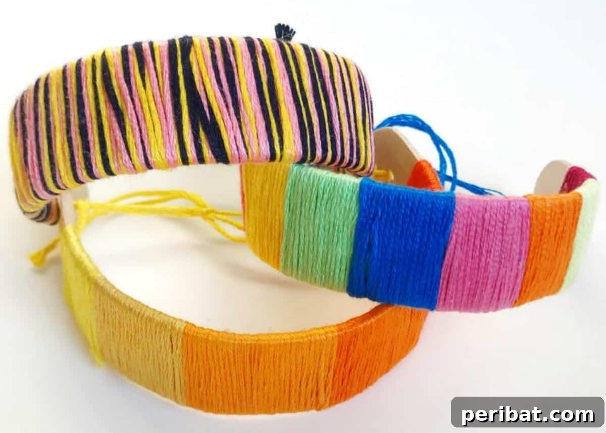 Children's hands holding colorful popsicle stick bracelets.