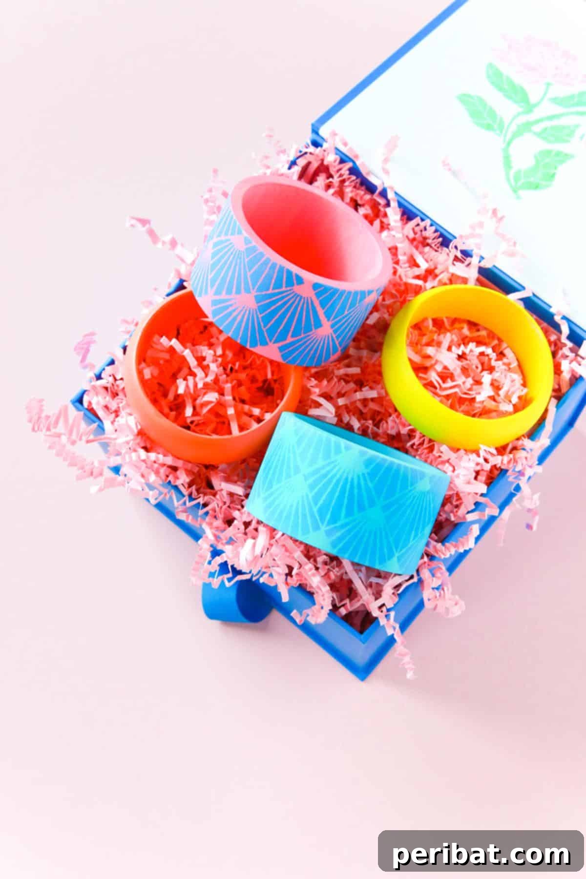 A stack of vibrant DIY colorful painted bangles with unique designs.