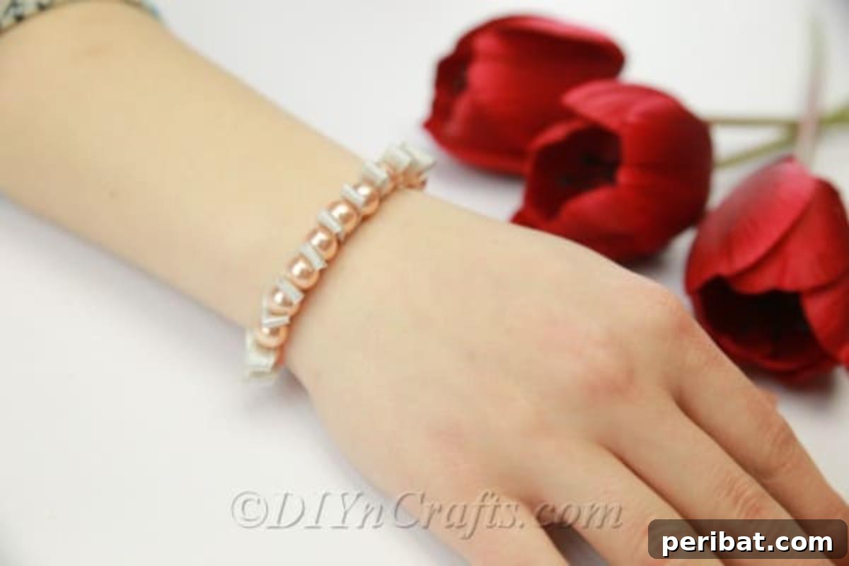 Elegant pearl and ribbon bracelet, showcasing a delicate design.