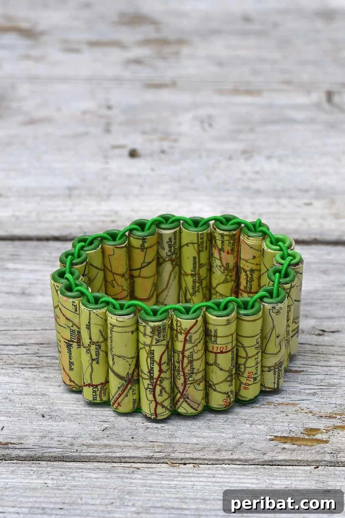 A unique bracelet made from intricately rolled paper beads.