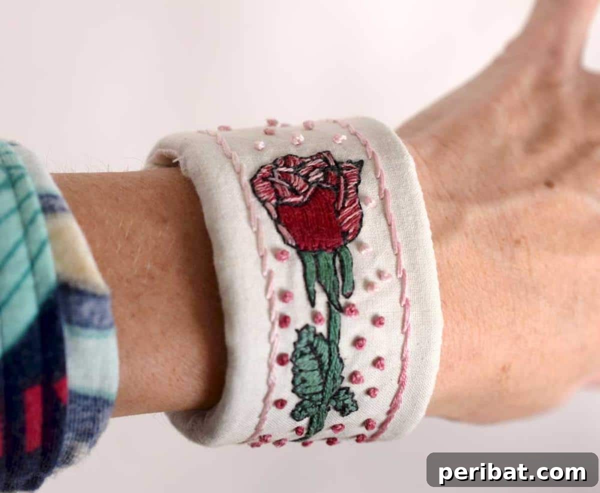 An intricately embroidered wrist cuff with colorful patterns.