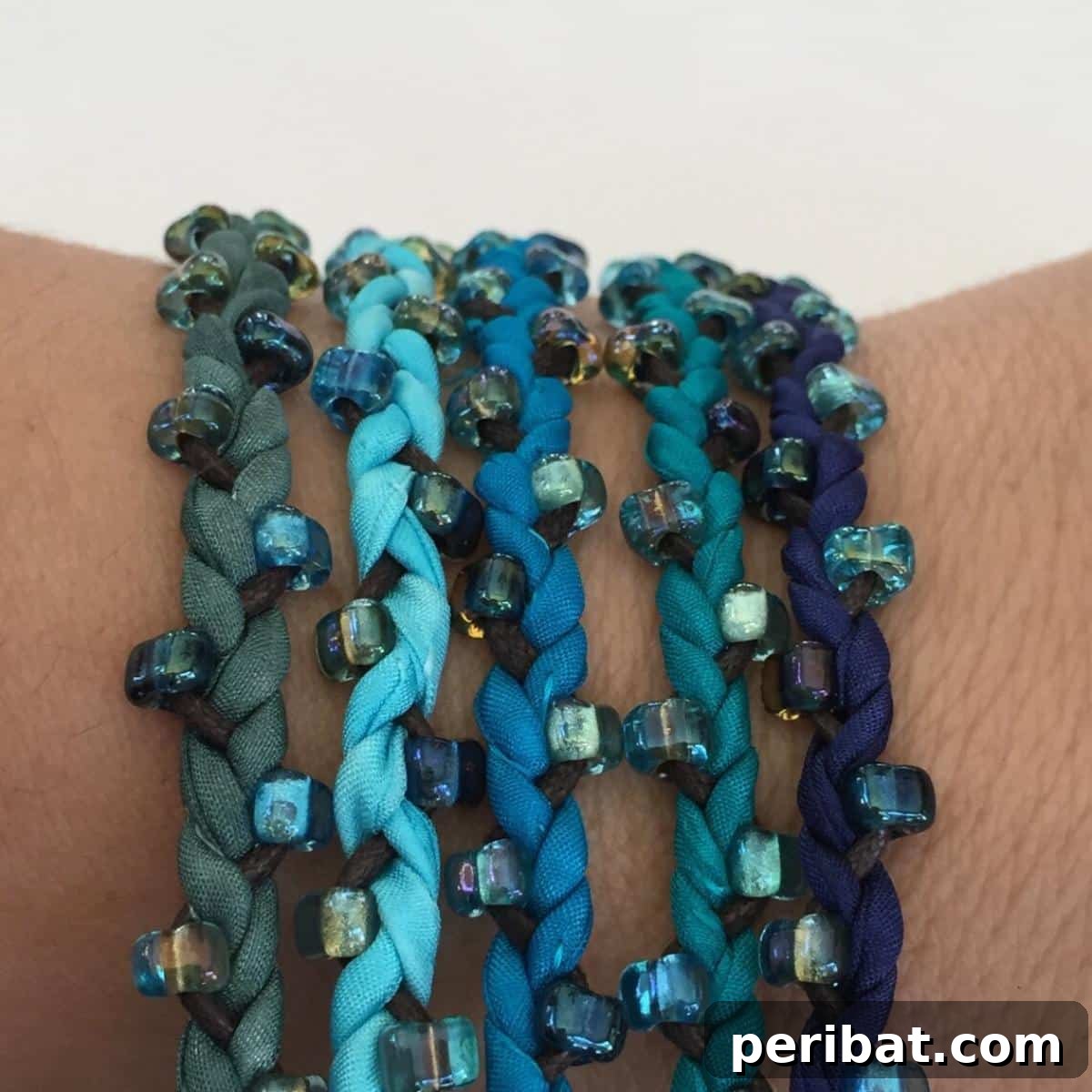 Luxurious DIY silk wrap bracelet supplies including silk cords, beads, and elegant charms.