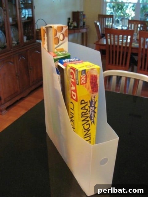 Magazine rack mounted inside a cabinet door to hold food wraps