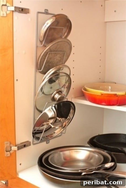 Magazine rack repurposed as a holder for pot lids inside a cabinet