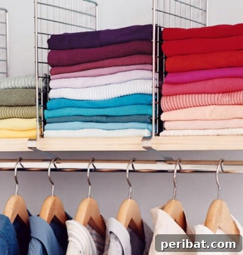 Closet shelf with dividers keeping sweaters and shirts neatly stacked
