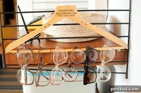 Eyeglasses and sunglasses hung on a clothes hanger for organization