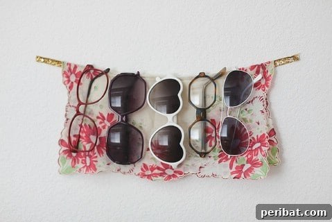 Sunglasses displayed on a decorative ribbon attached to a wall