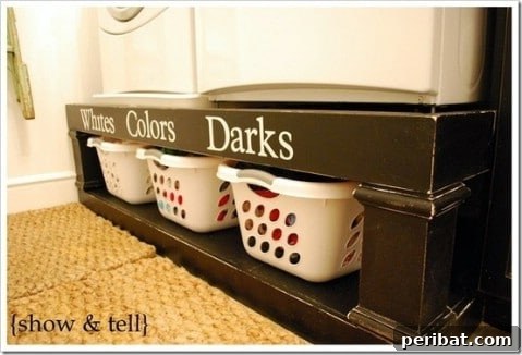 Custom shelf built over a washer and dryer with neatly organized laundry items