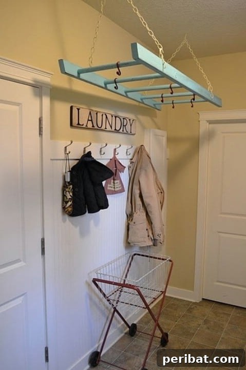 Decorative wooden ladder hung horizontally for air-drying clothes in a laundry room