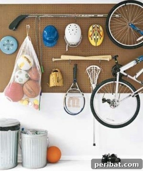 Pegboard with hooks organizing various sport gears and helmets in a garage