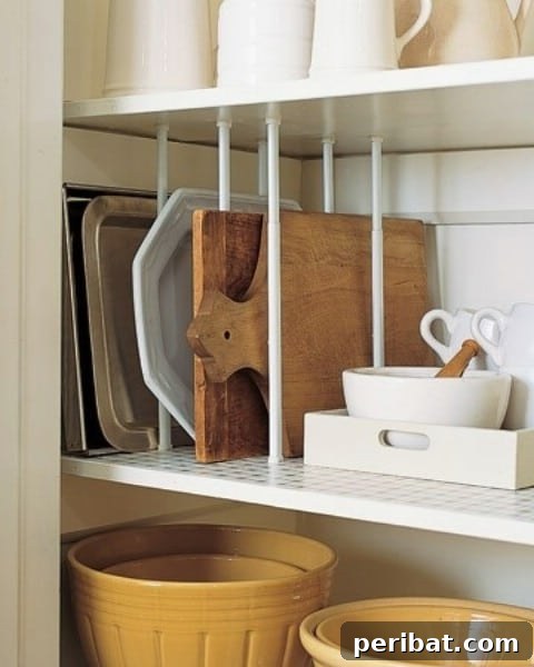 Tension curtain rods used as dividers for baking sheets in a cabinet