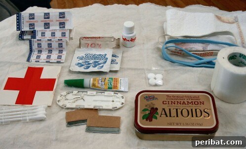 55+ Ultimate Camping Hacks to Master the Wilderness 50 An Altoids tin repurposed into a compact mini first aid kit for small injuries and emergencies on hikes.