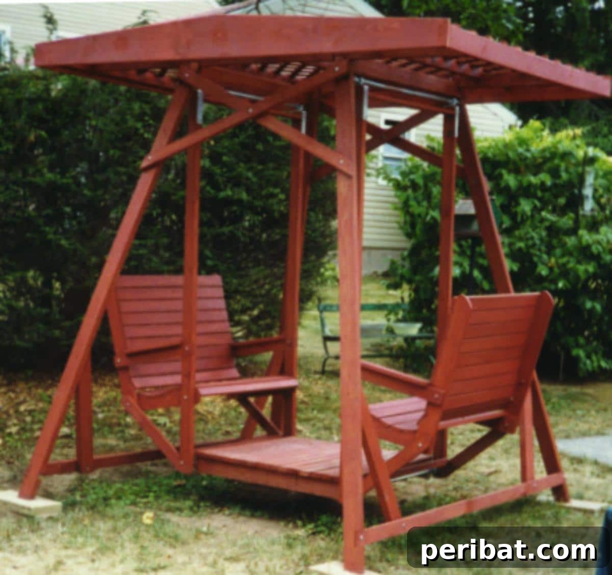 A charming garden swing designed for two, complete with an integrated awning for shade, creating a perfect intimate outdoor setting.